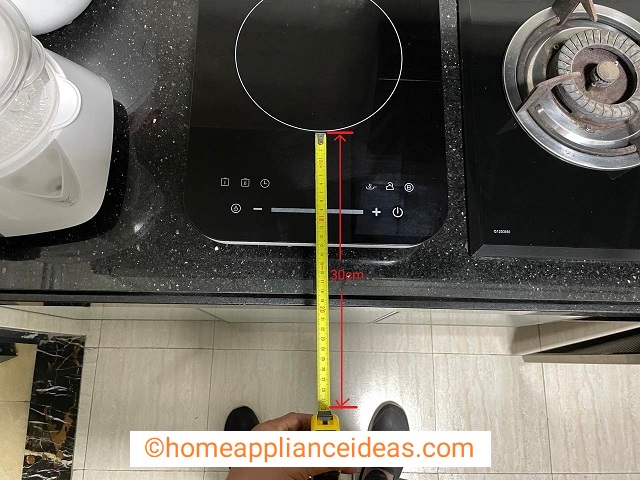 Photo of a kitchen top with single induction hob showing 30cm distance